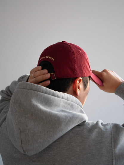 A red cap with Local Runner embroidery