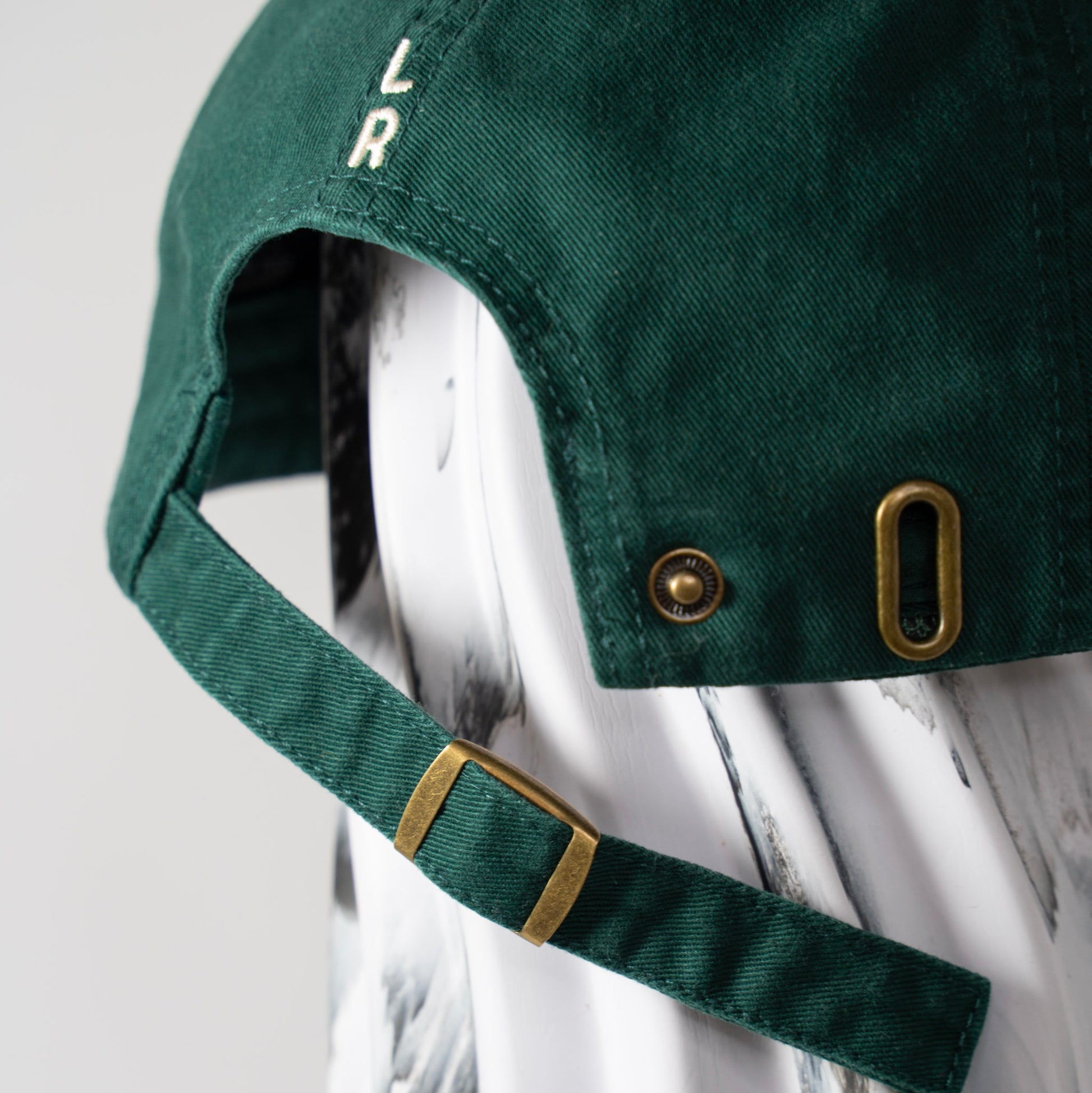 A green cap with LR embroidery