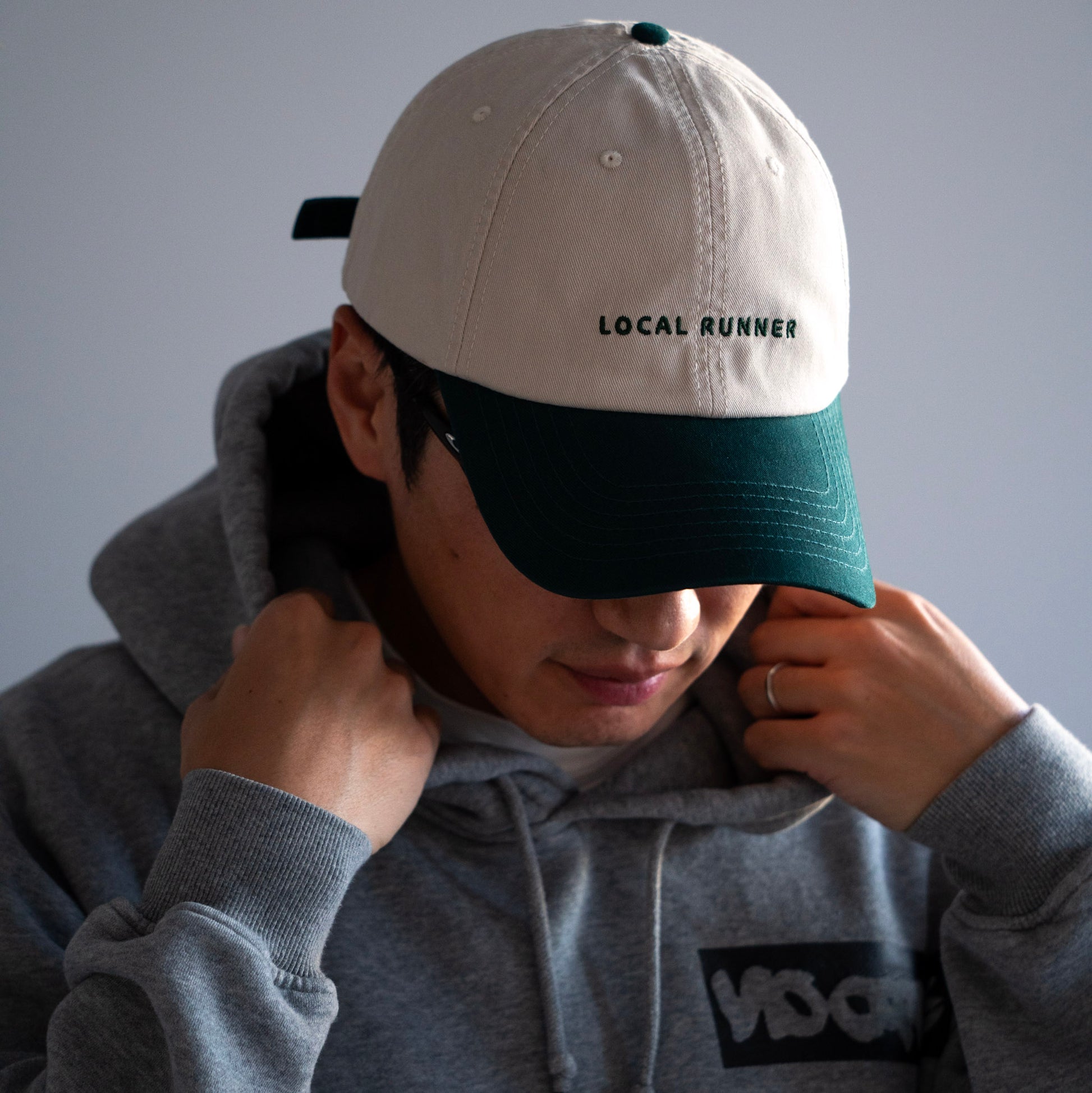 A two tone cap with 'LOCAL RUNNER' embroidery