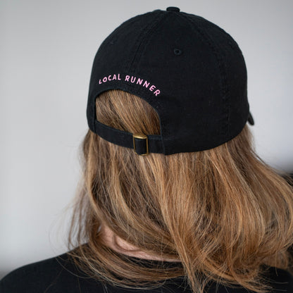 A black cap with 'LOCAL RUNNER' embroidery