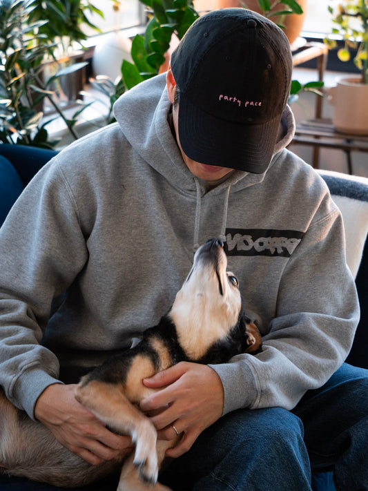 A black cap with party pace embroidery