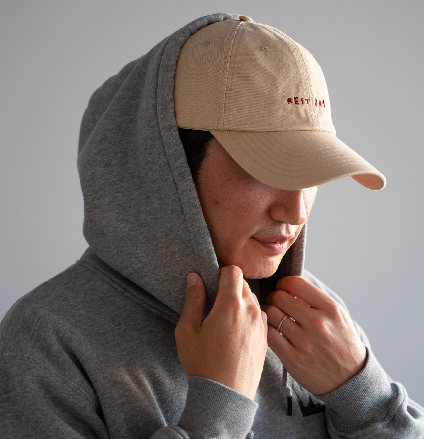 A beige cap with Rest Day embroidery