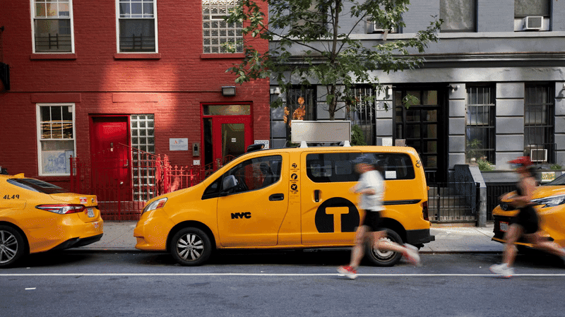 A GIF image with three people running next to a NYC yellow cap on the street.